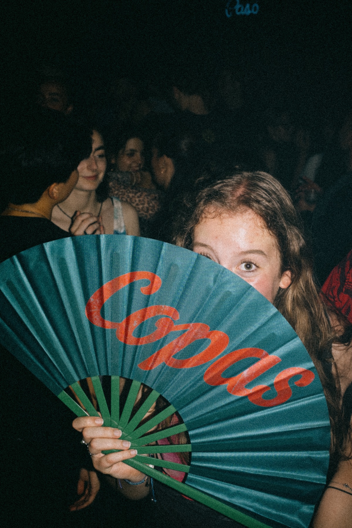 Guest holding a Copas fan on the dance floor